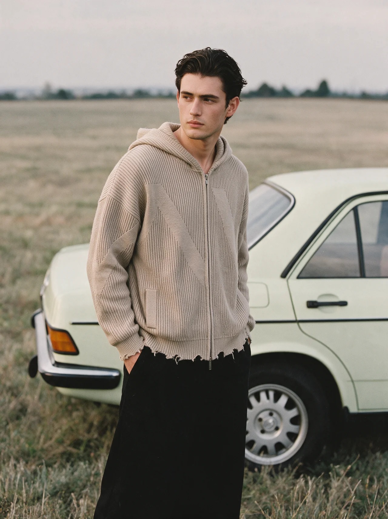 OCTAVE Theory model wearing the new zip hoodie beside a vintage car in a field